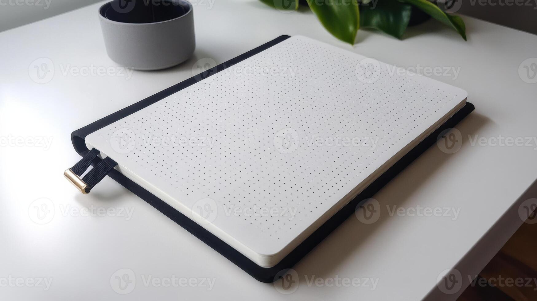 simple bullet journal with blank dotted pages on table photo