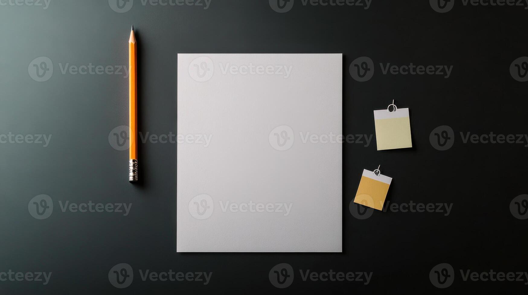 Blank paper, pencil, and sticky notes on a black surface photo