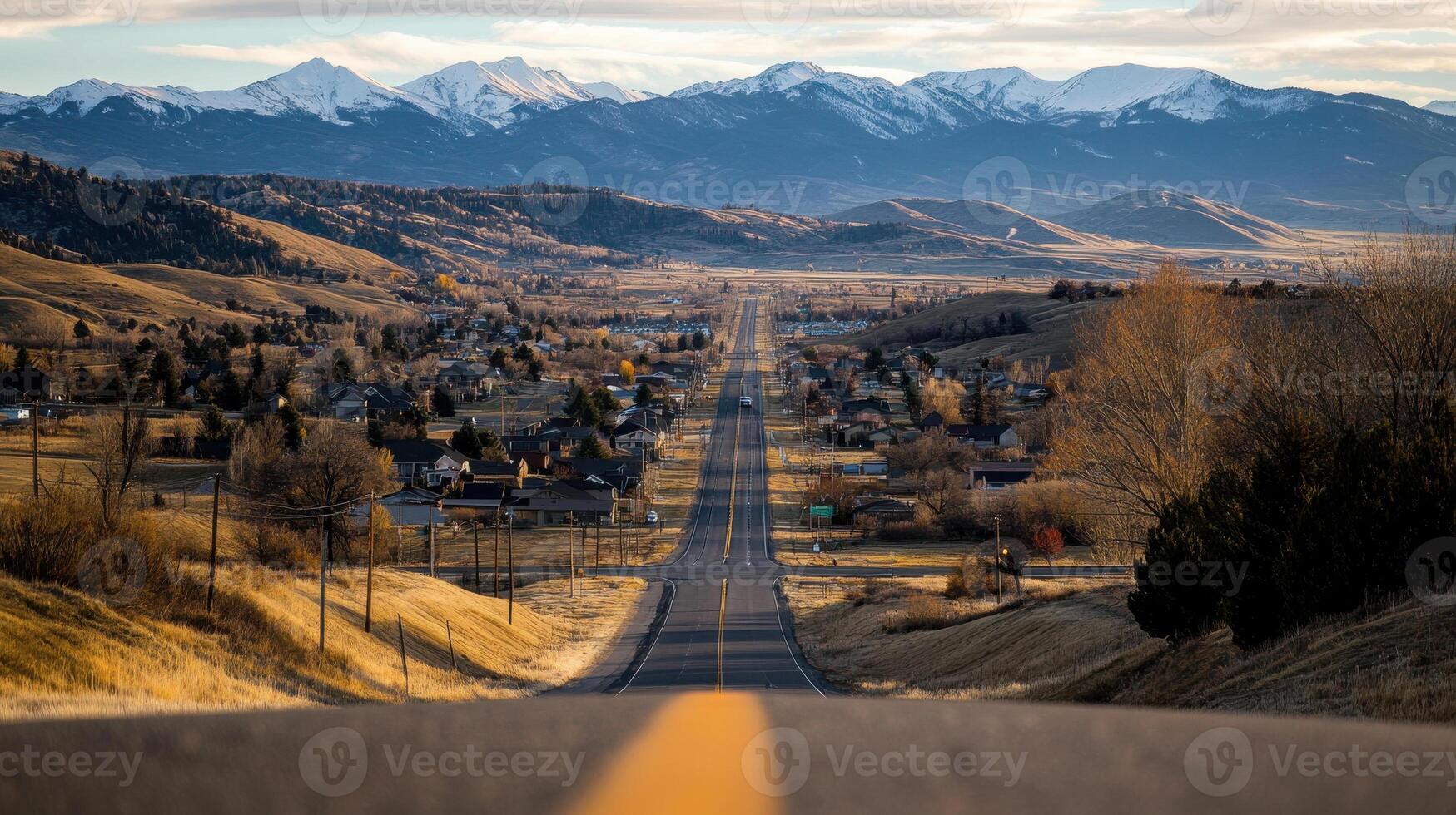 scenic view of small town with mountains in background photo