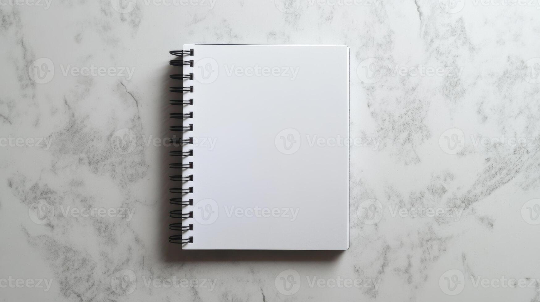 Blank spiral notebook on marble surface for creativity photo