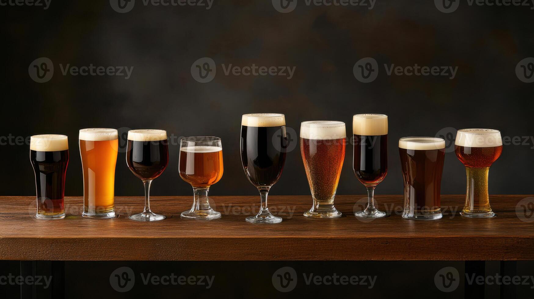 A variety of beer glasses on a wooden table photo