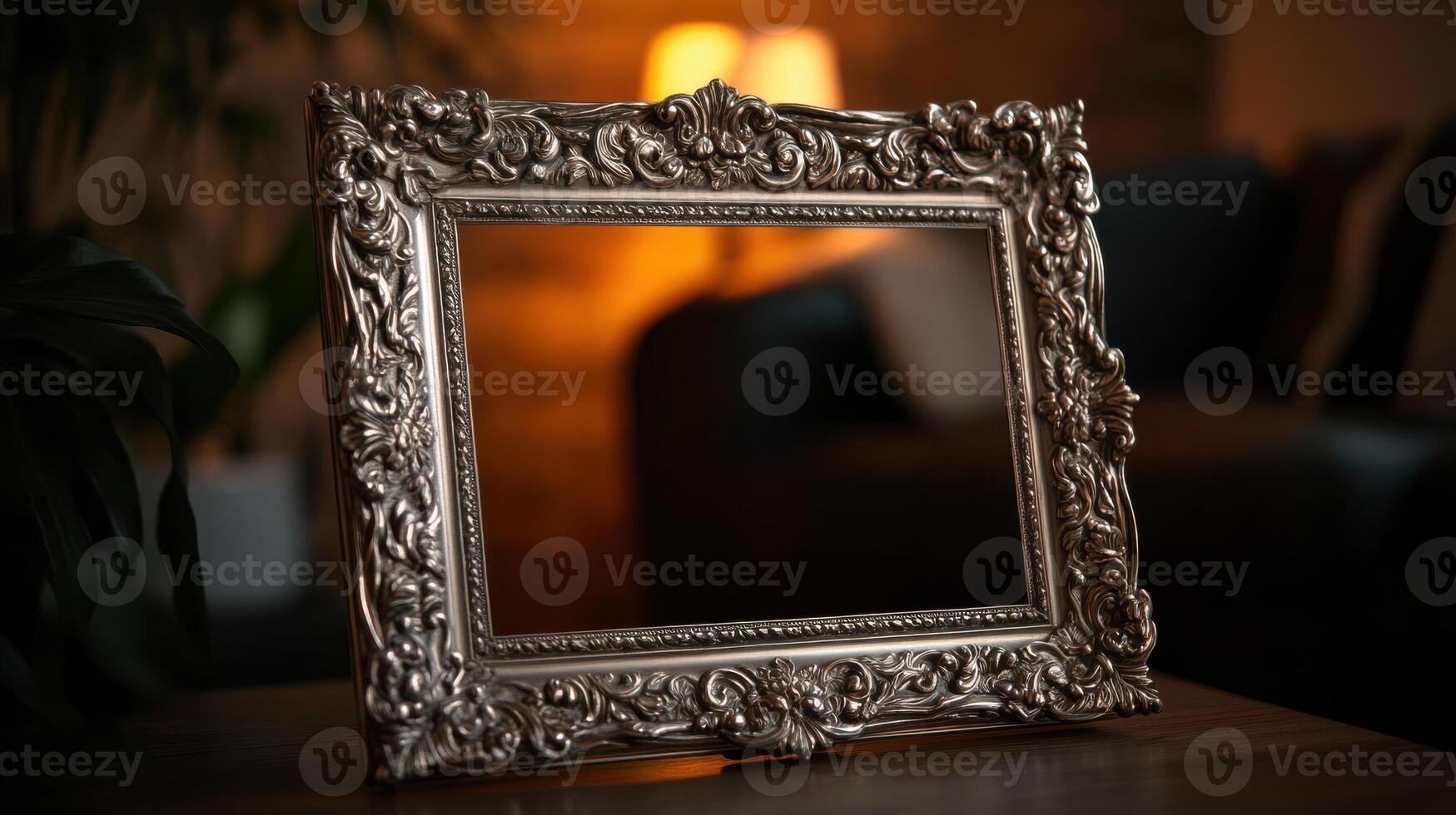 A silver frame sitting on a table in front of a lamp photo