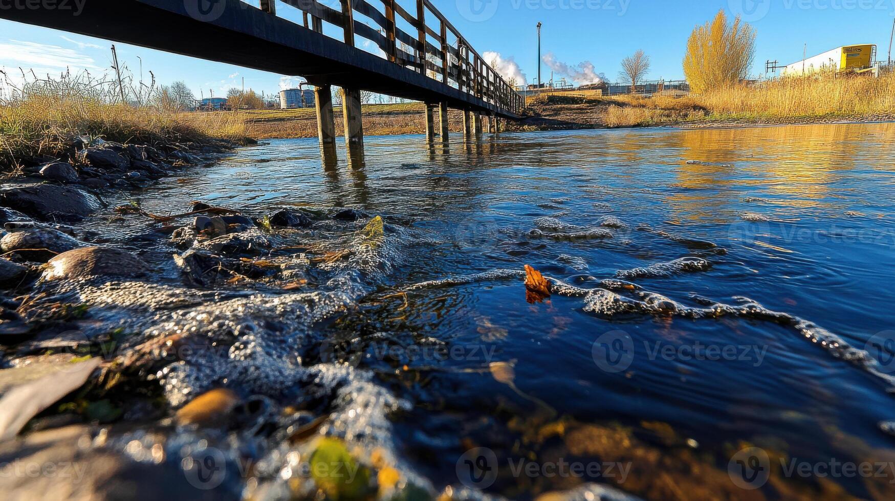 A bridge over a river with a small body of water photo