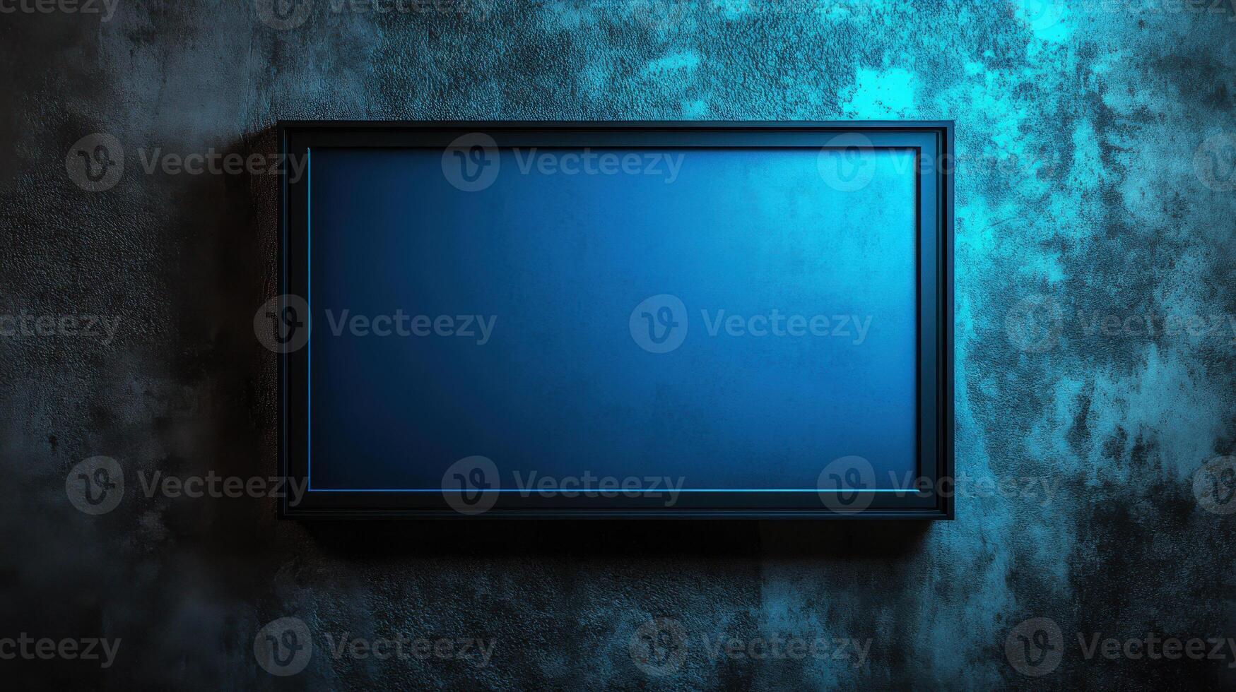 Empty metal picture frame on textured wall with blue light photo