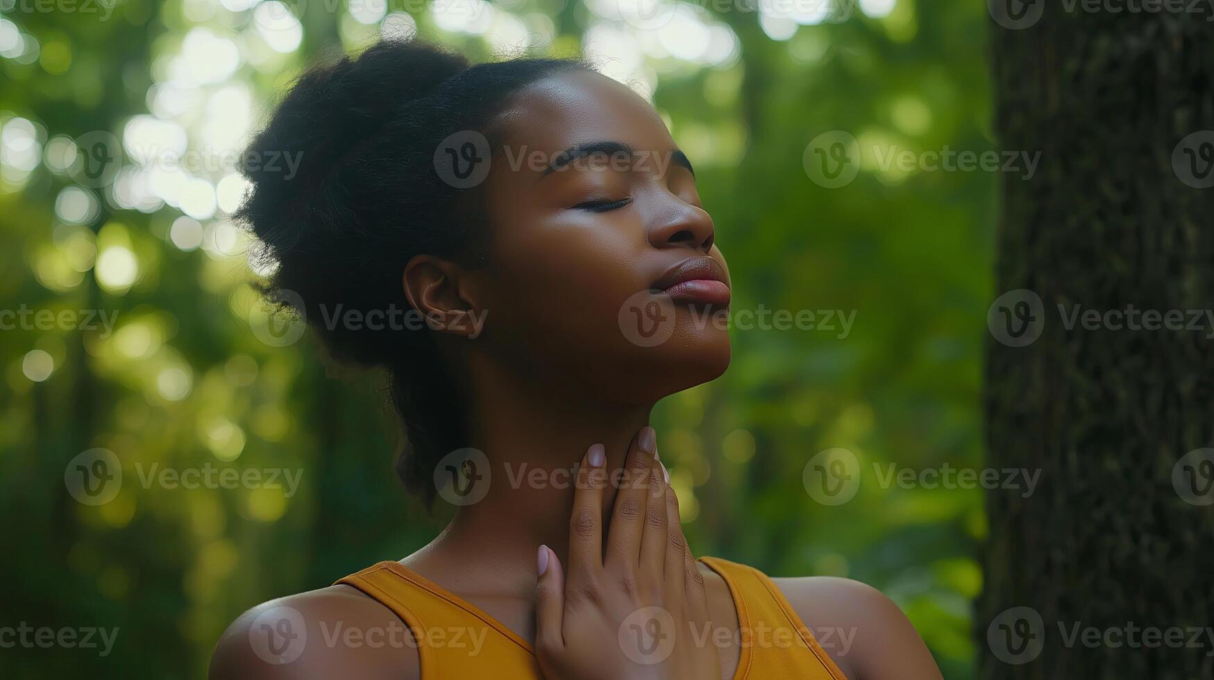 Black Woman Practicing Deep Breathing with Hand on Chest photo