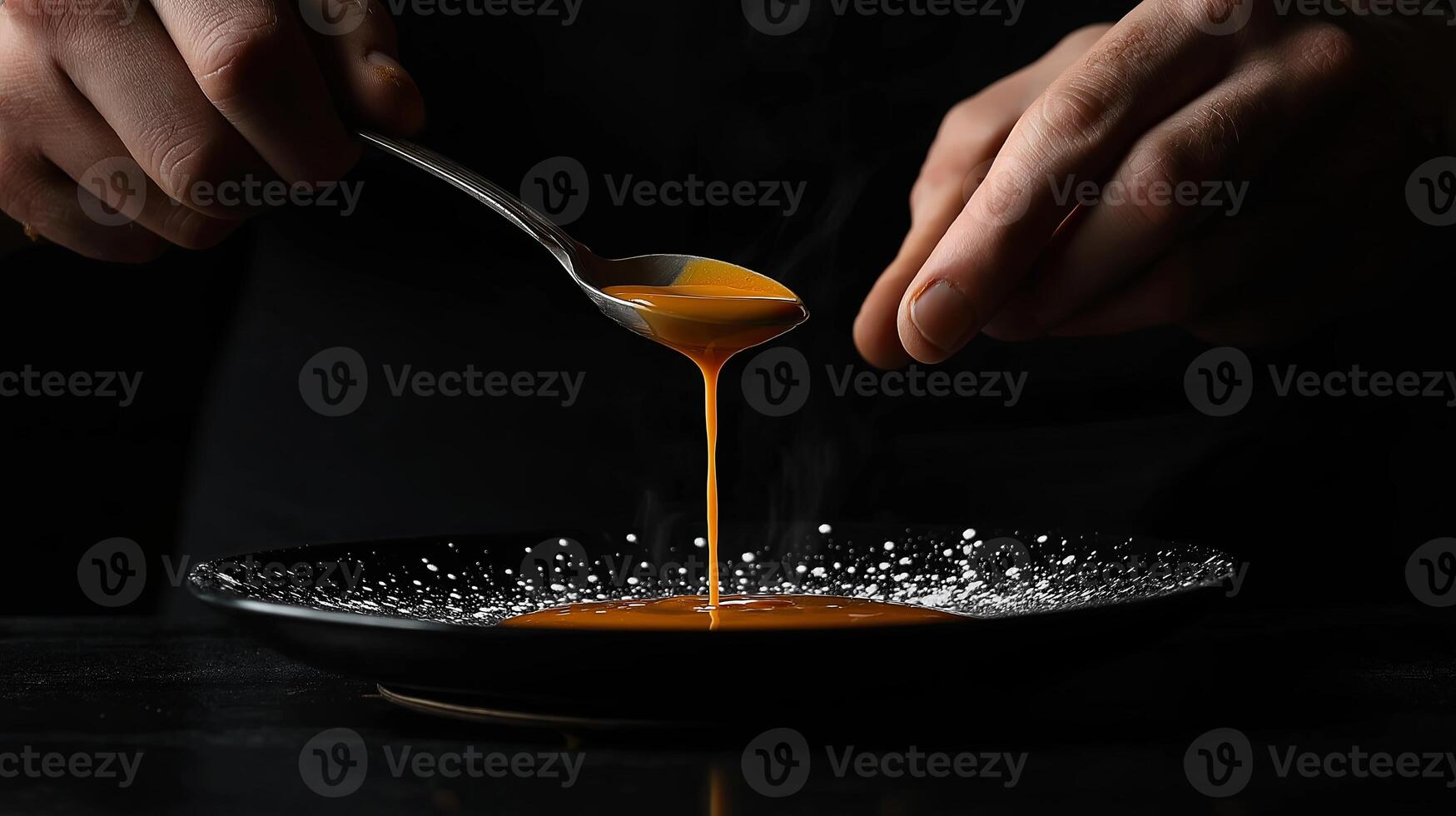 A close-up of a male chef hands carefully pouring a rich sauce over a plated dish in a professional kitchen, highlighting culinary artistry. photo