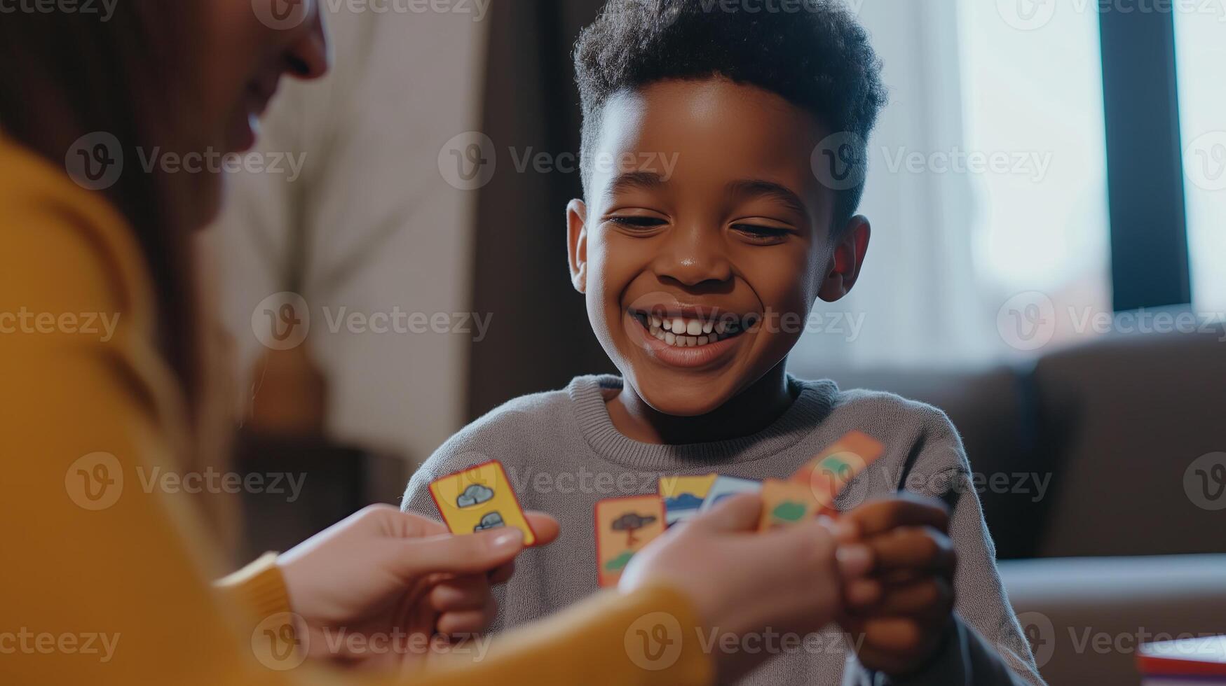 A smiling child playing an educational card game with an adult, representing fun learning, early childhood education, and cognitive development. photo