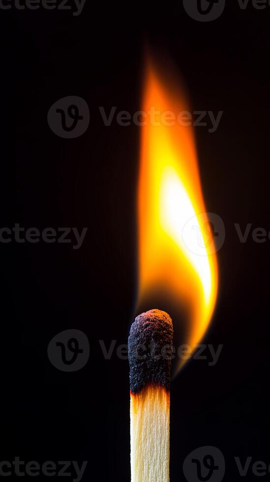 A single matchstick ignited with a strong, dramatic flame against a deep black background, symbolizing energy, ignition, and power. photo