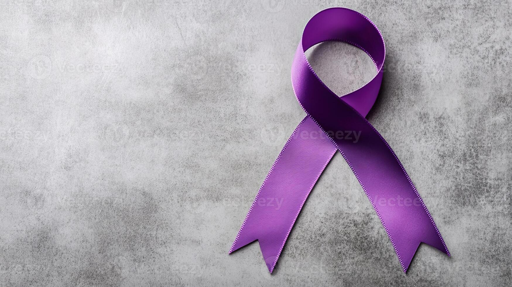 A symbolic purple ribbon placed on a textured gray surface, representing advocacy, awareness, and support for important causes. photo