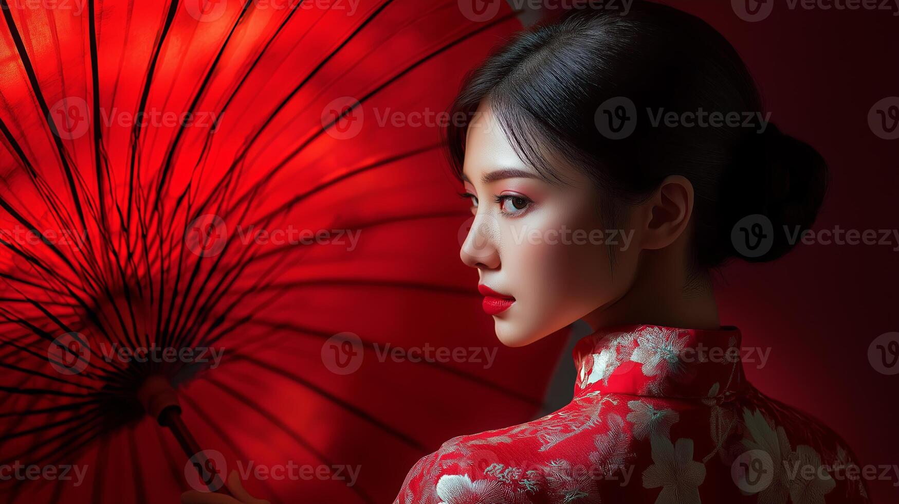 Elegant Asian woman in a red dress holding a traditional Chinese umbrella photo