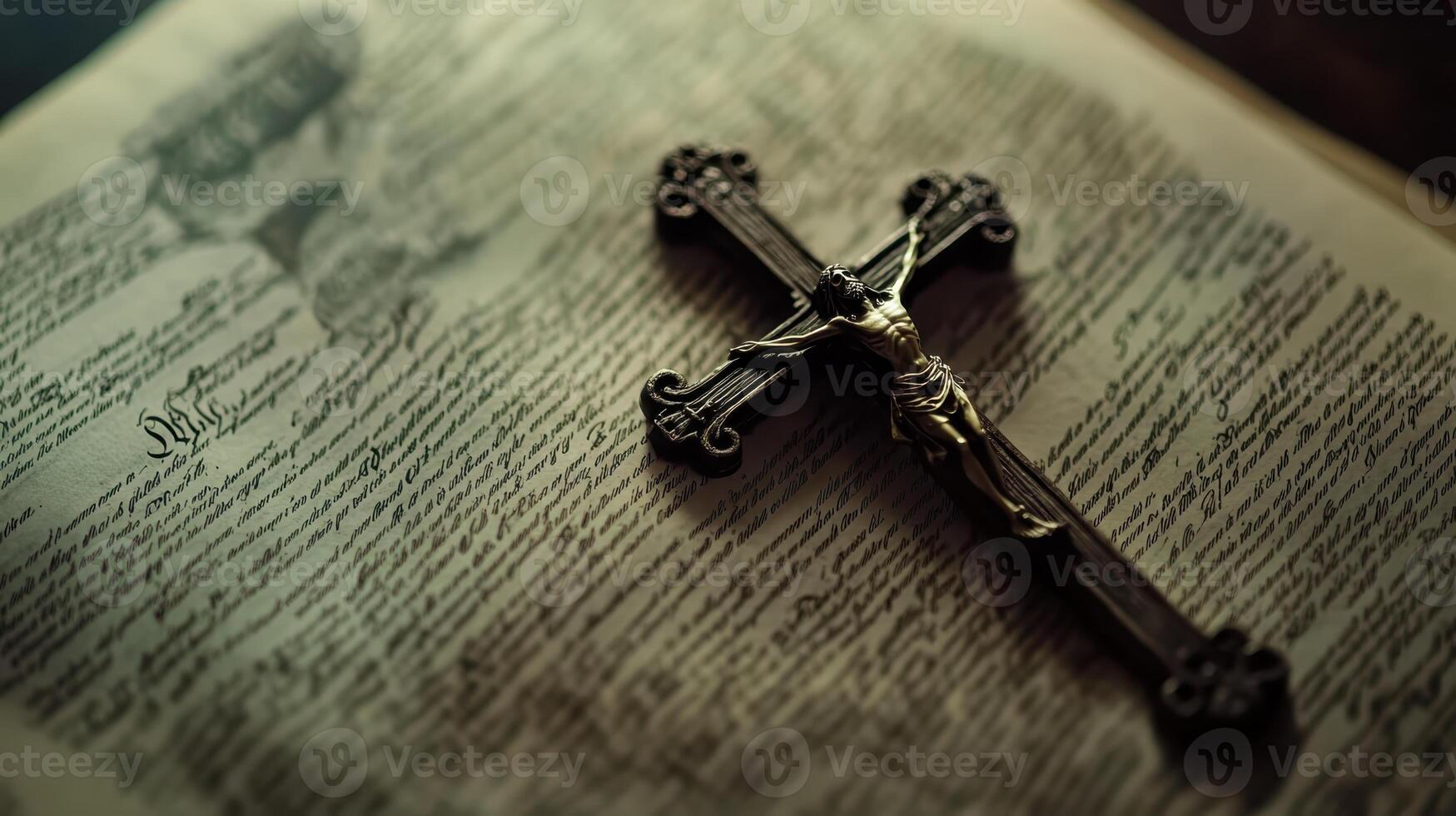 A blackened metal crucifix resting on the pages of an open Bible, representing Christian faith, devotion, and religious symbolism. photo
