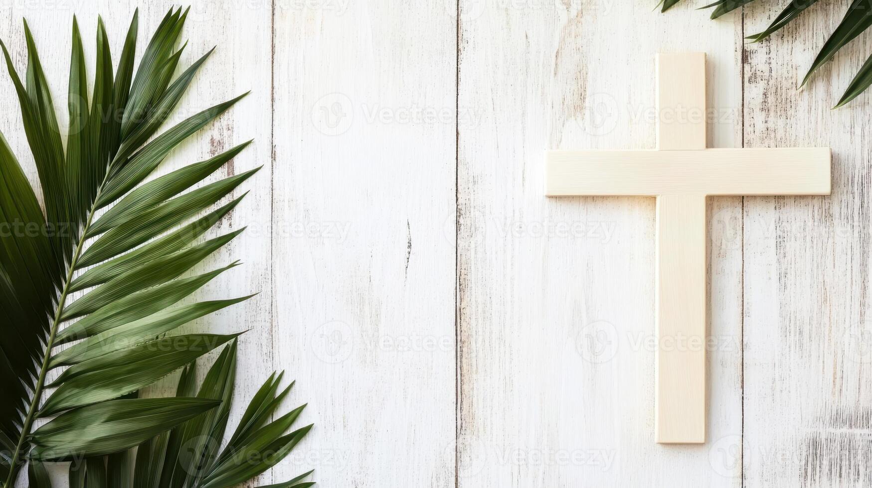 A pale wooden cross placed next to palm leaves on a white wooden background, representing Christian faith, Palm Sunday, and Easter. photo