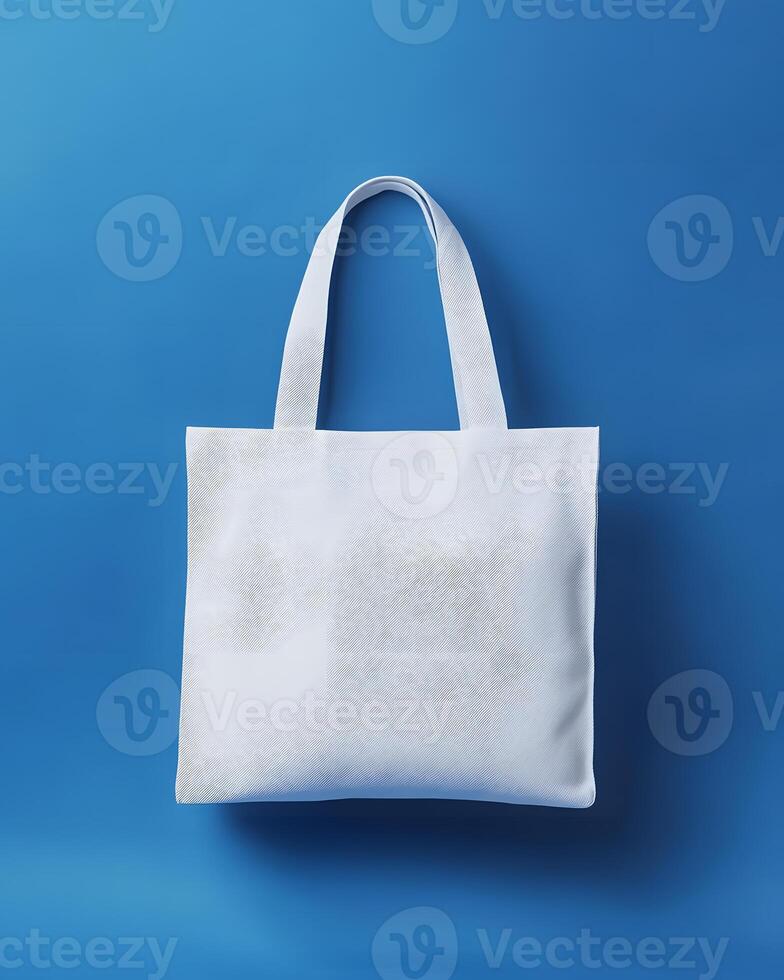 White Canvas Tote Bag Mock up Against Blue Background photo