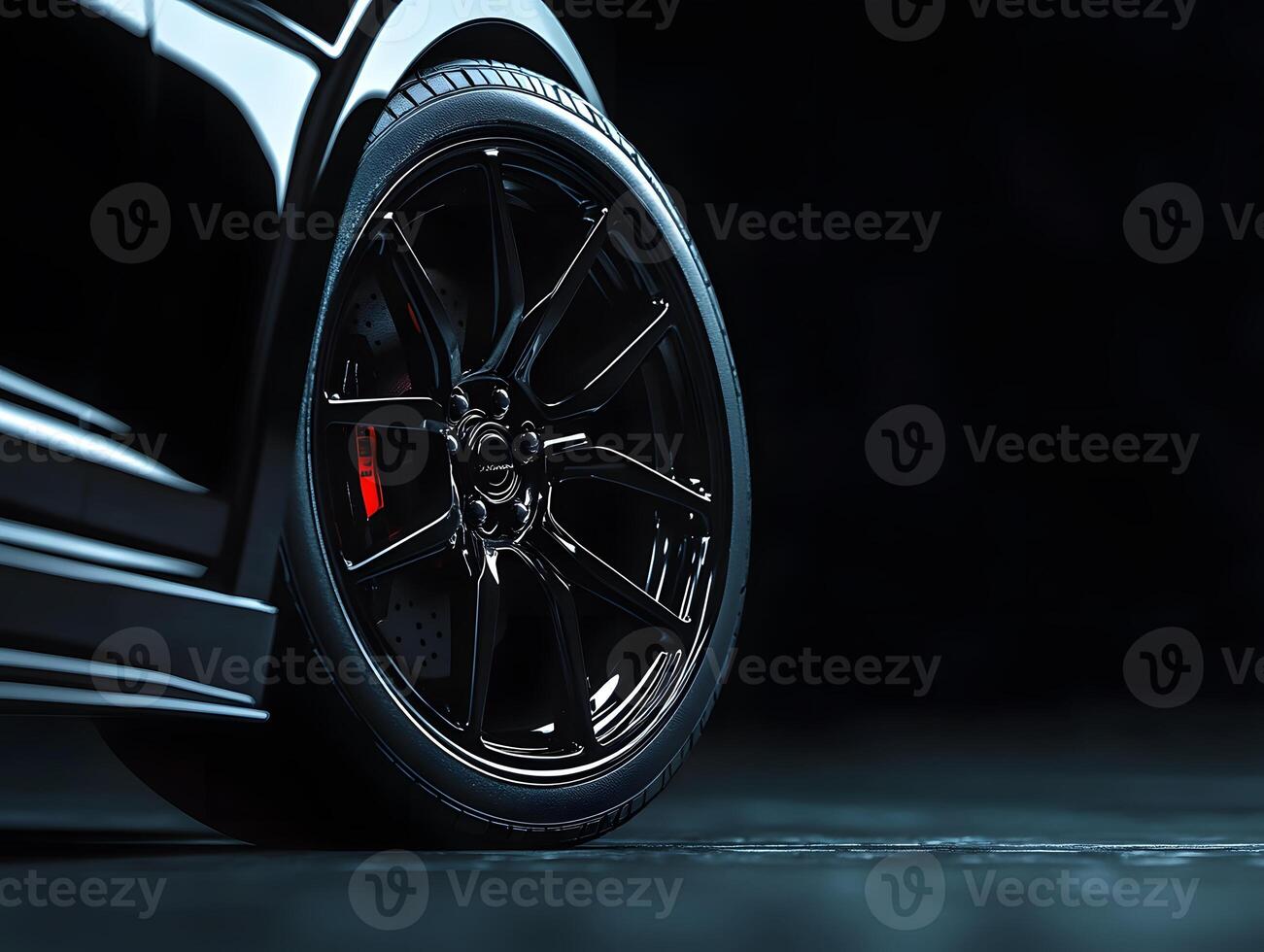 Black Car Wheel and Tire with Red Brake Caliper photo