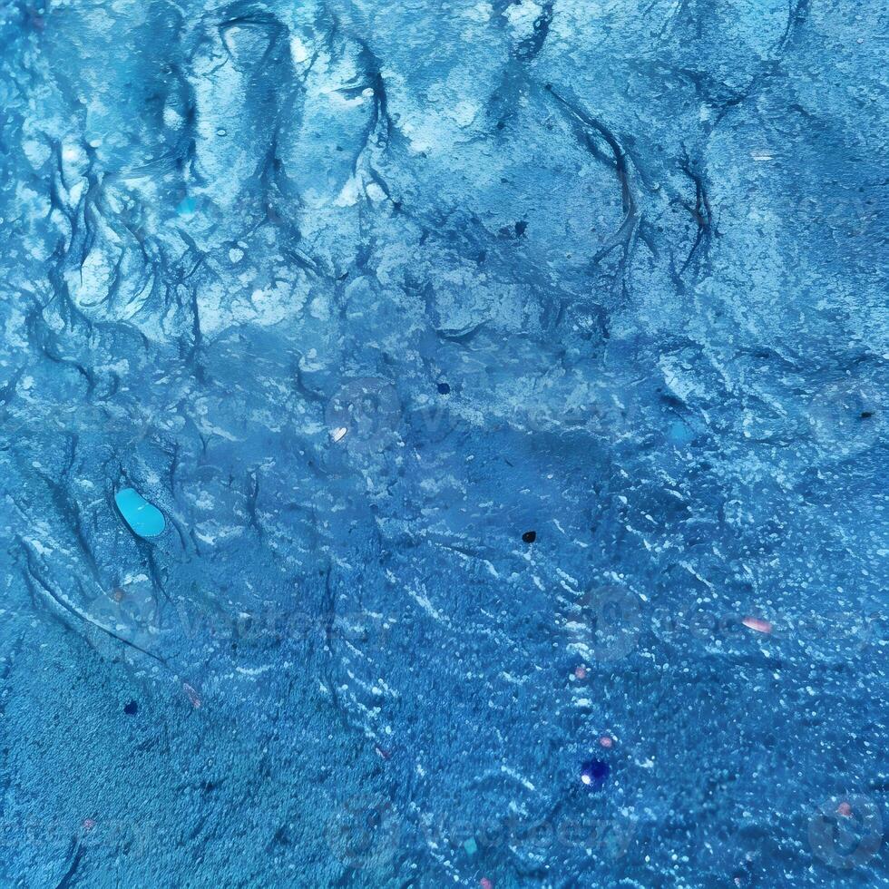 Blue Textured Surface with Embedded Objects and Linear Patterns photo