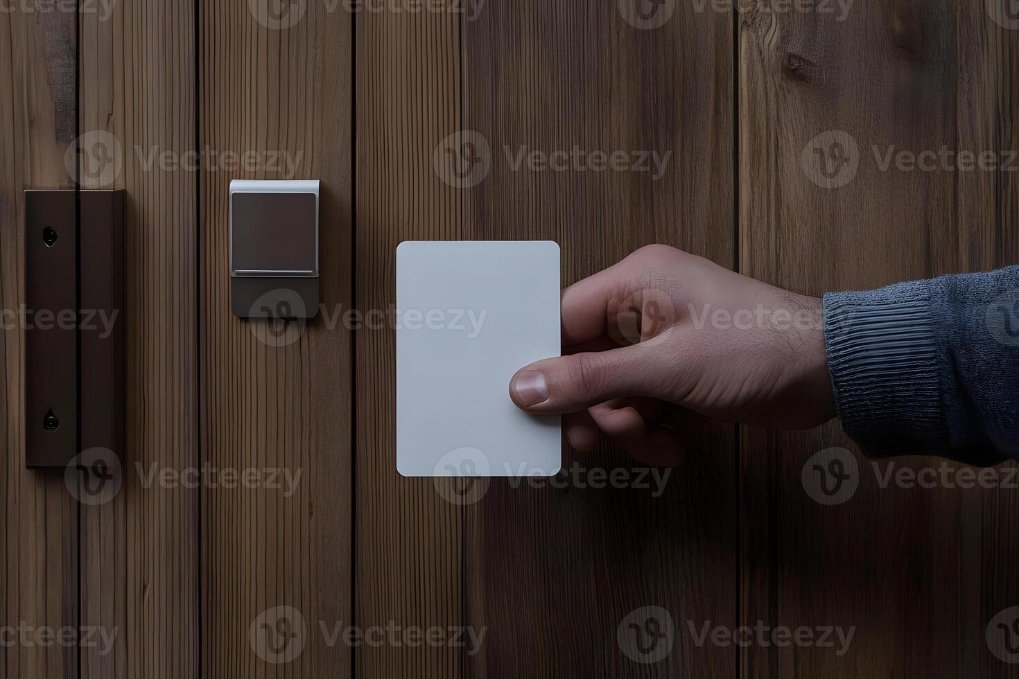 Hand Holding Blank Card Near Electronic Door Access Panel photo