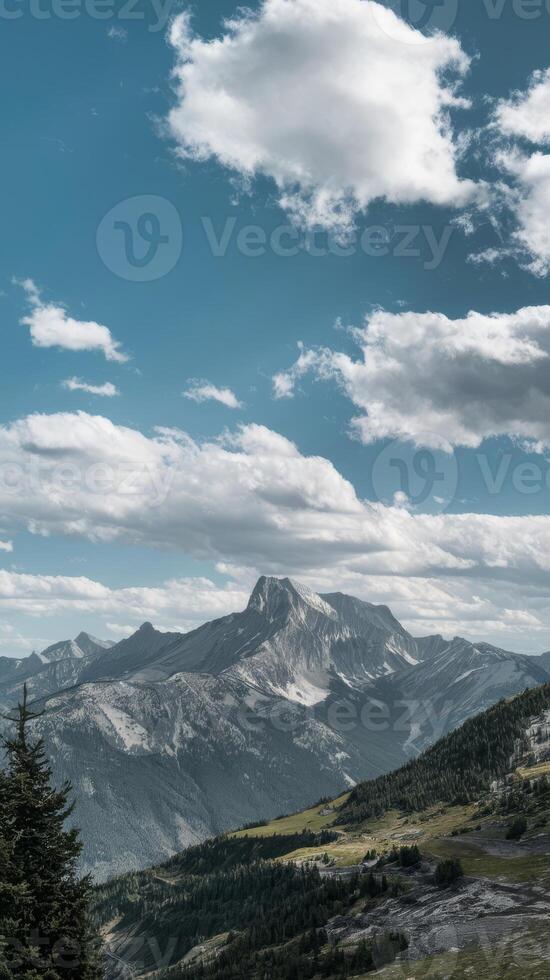 A mountain range with trees and clouds photo