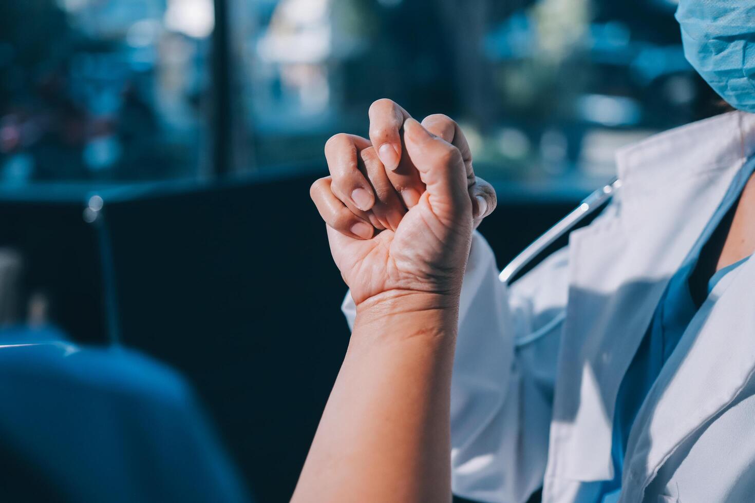 A doctor is holding the hand of a patient photo