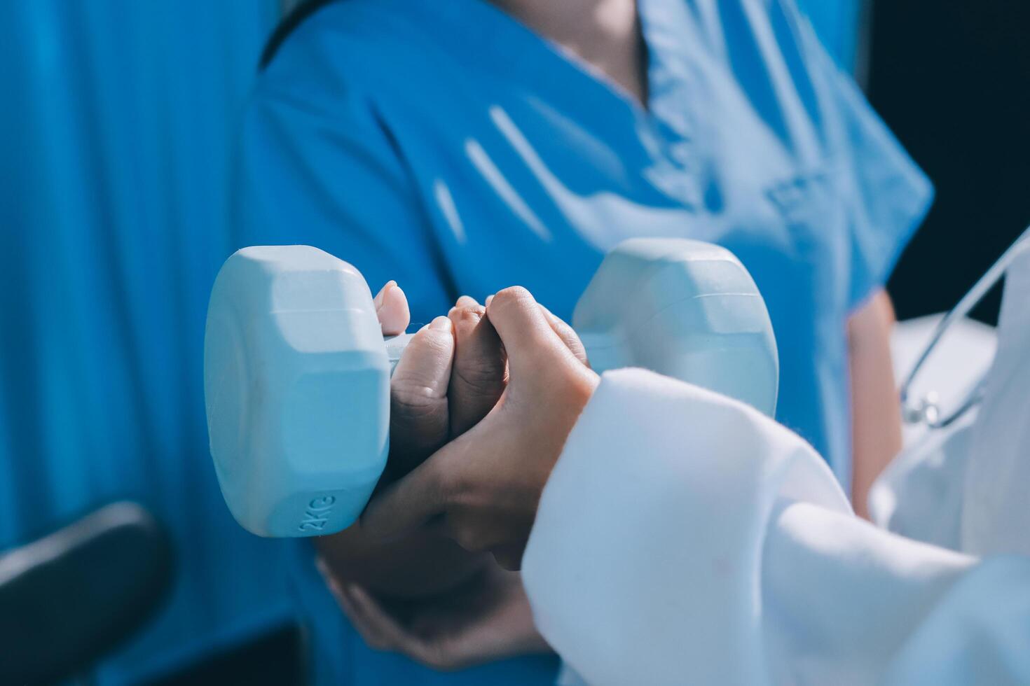 A doctor is holding a dumbbell in front of a patient photo