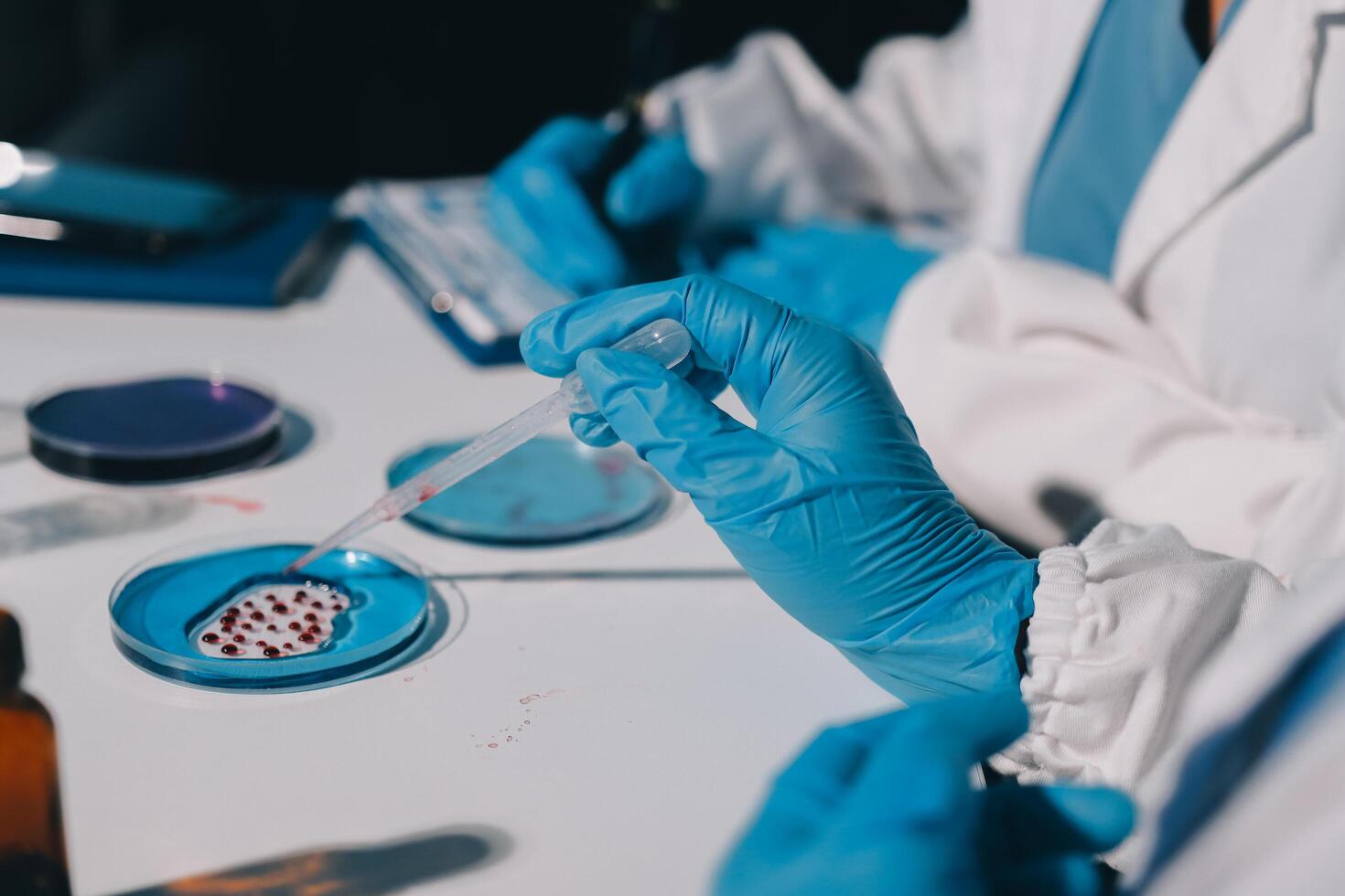 A person in a lab coat is holding a test tube photo