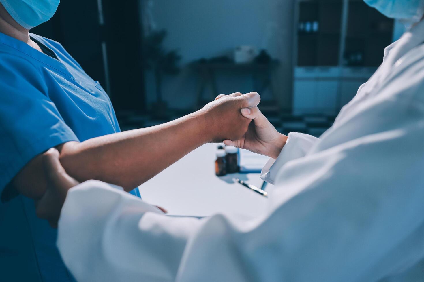 A doctor is shaking hands with another person photo