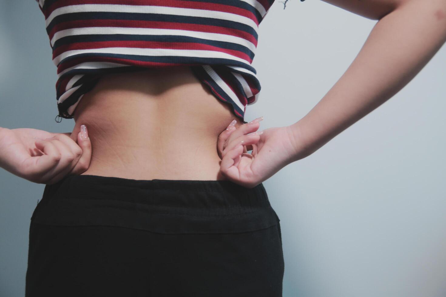 A woman with her hands on her stomach photo