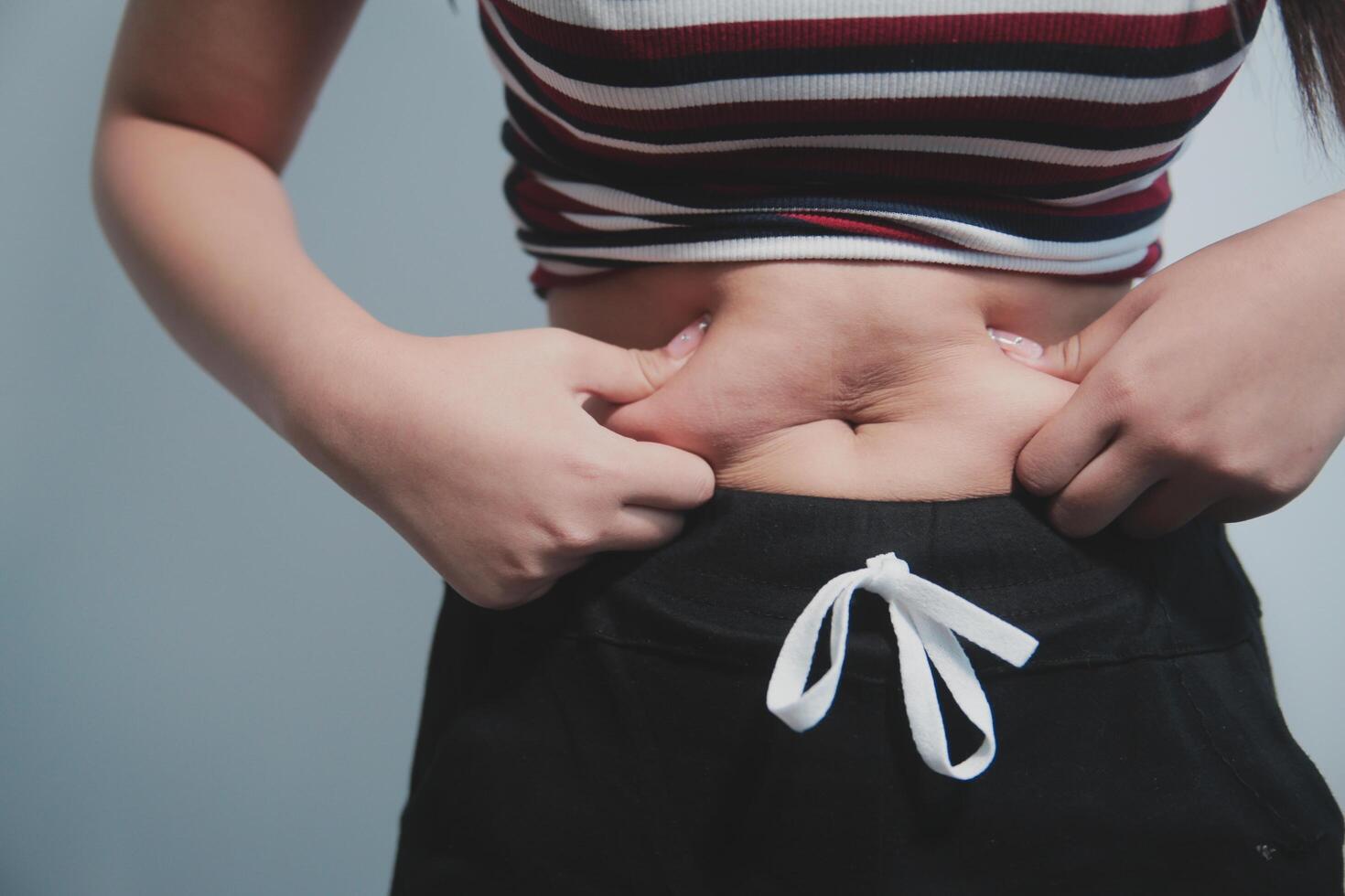 A woman is holding her stomach photo