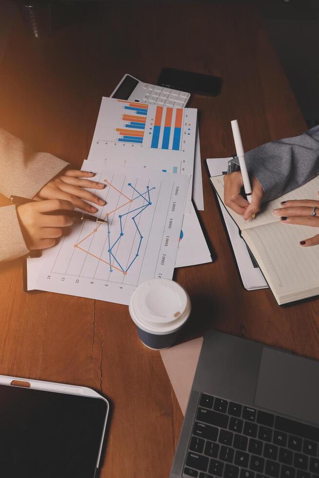 Business people working at a desk with papers and pens photo