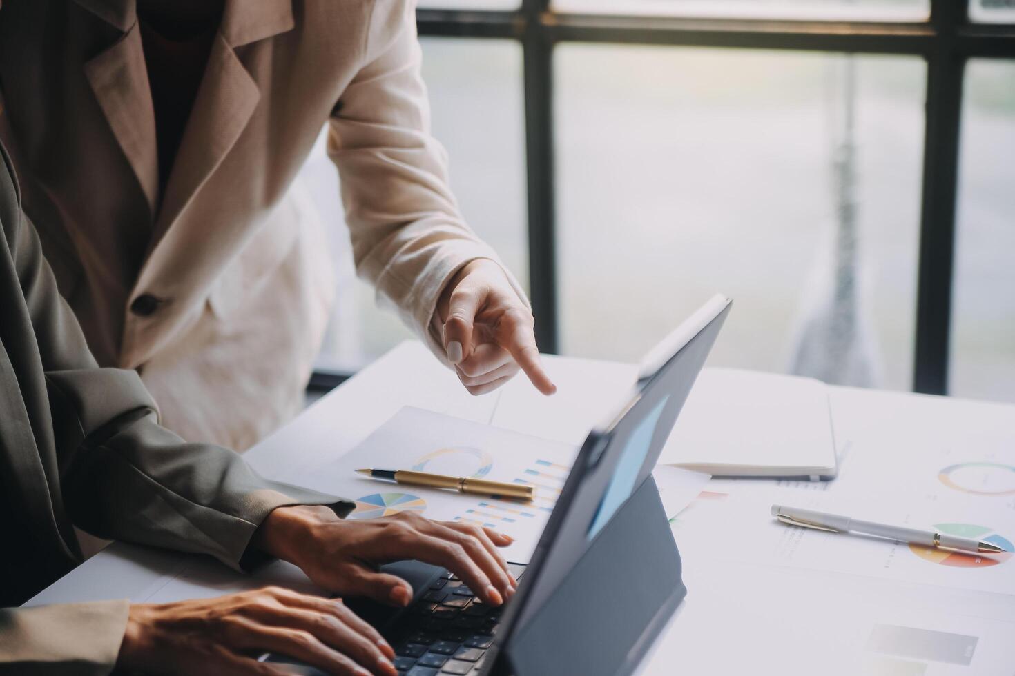 Two business people working on a laptop photo