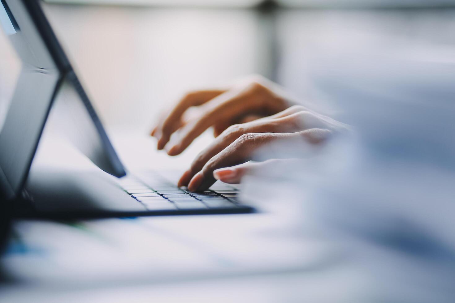 A person typing on a laptop computer photo