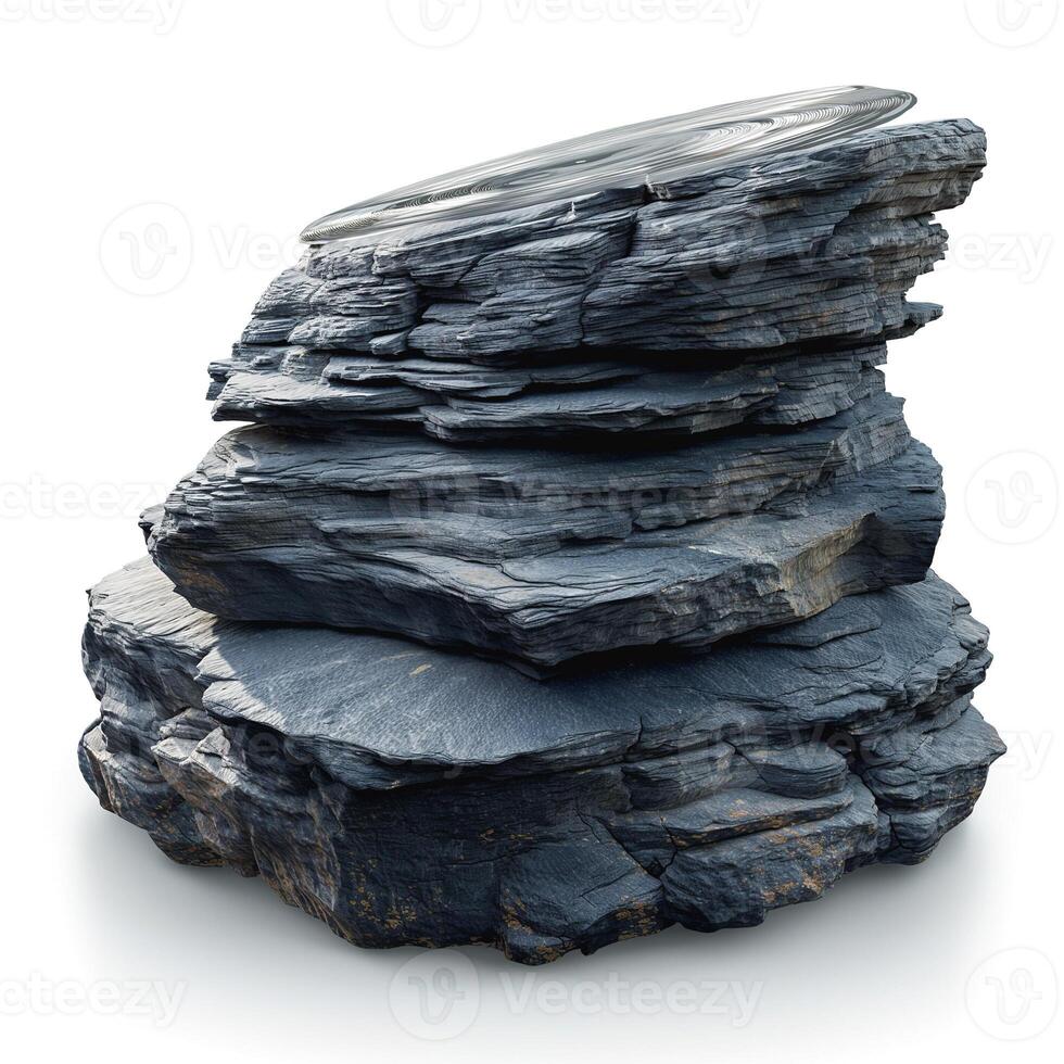 A stack of dark, layered rocks topped with a circular metal object, creating a striking contrast between nature and modernity. photo