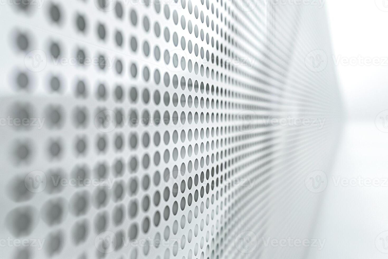 Abstract close-up of a textured wall with a series of perforated dots in shades of gray. photo