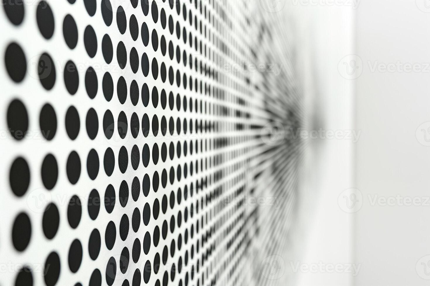 A close-up of a modern art piece featuring a pattern of black dots radiating outward on a white background. photo