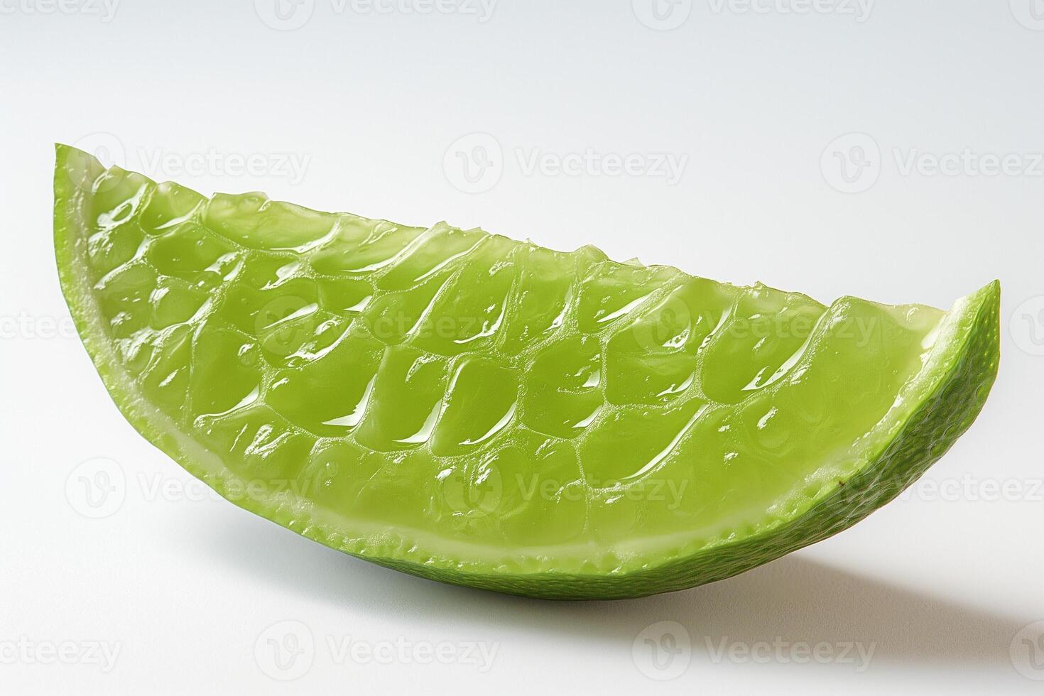 A vibrant green slice of aloe vera showcasing its jelly-like interior. photo
