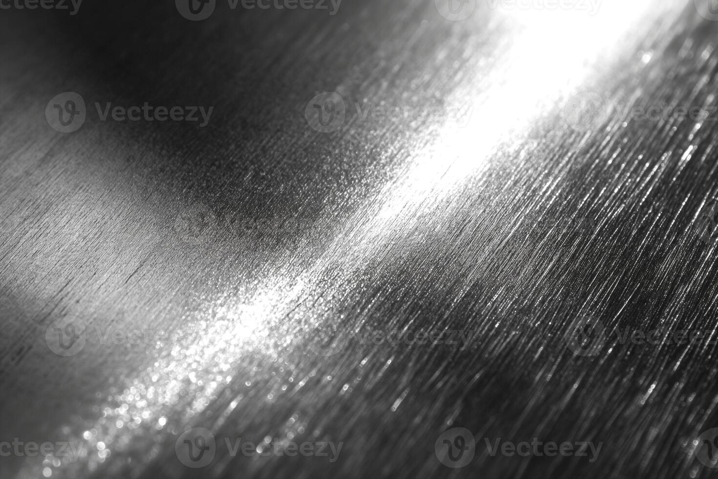 Close-up of polished metal surface showing reflections and intricate texture. photo