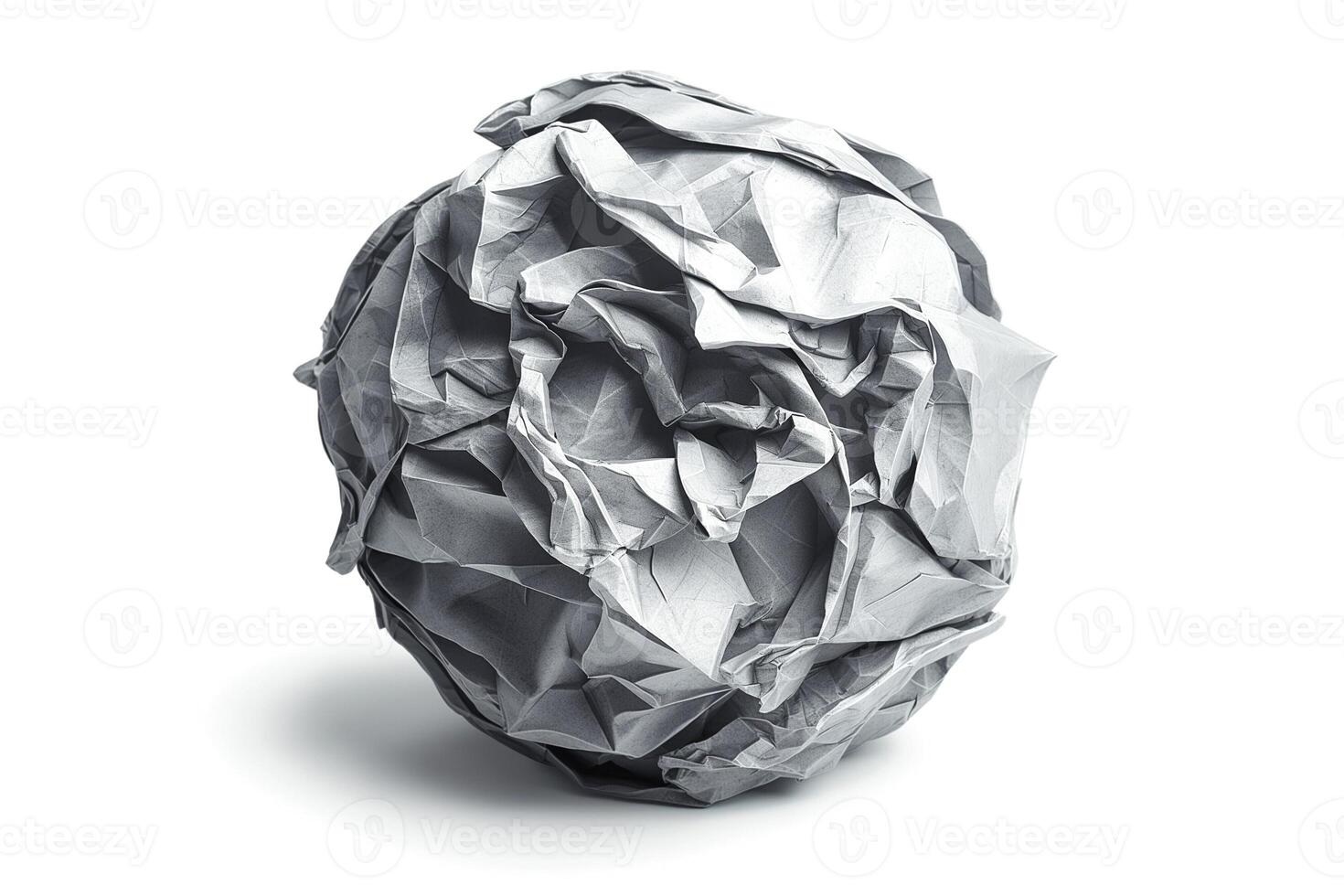 A crumpled paper ball on a clean white background, showcasing texture and form. photo