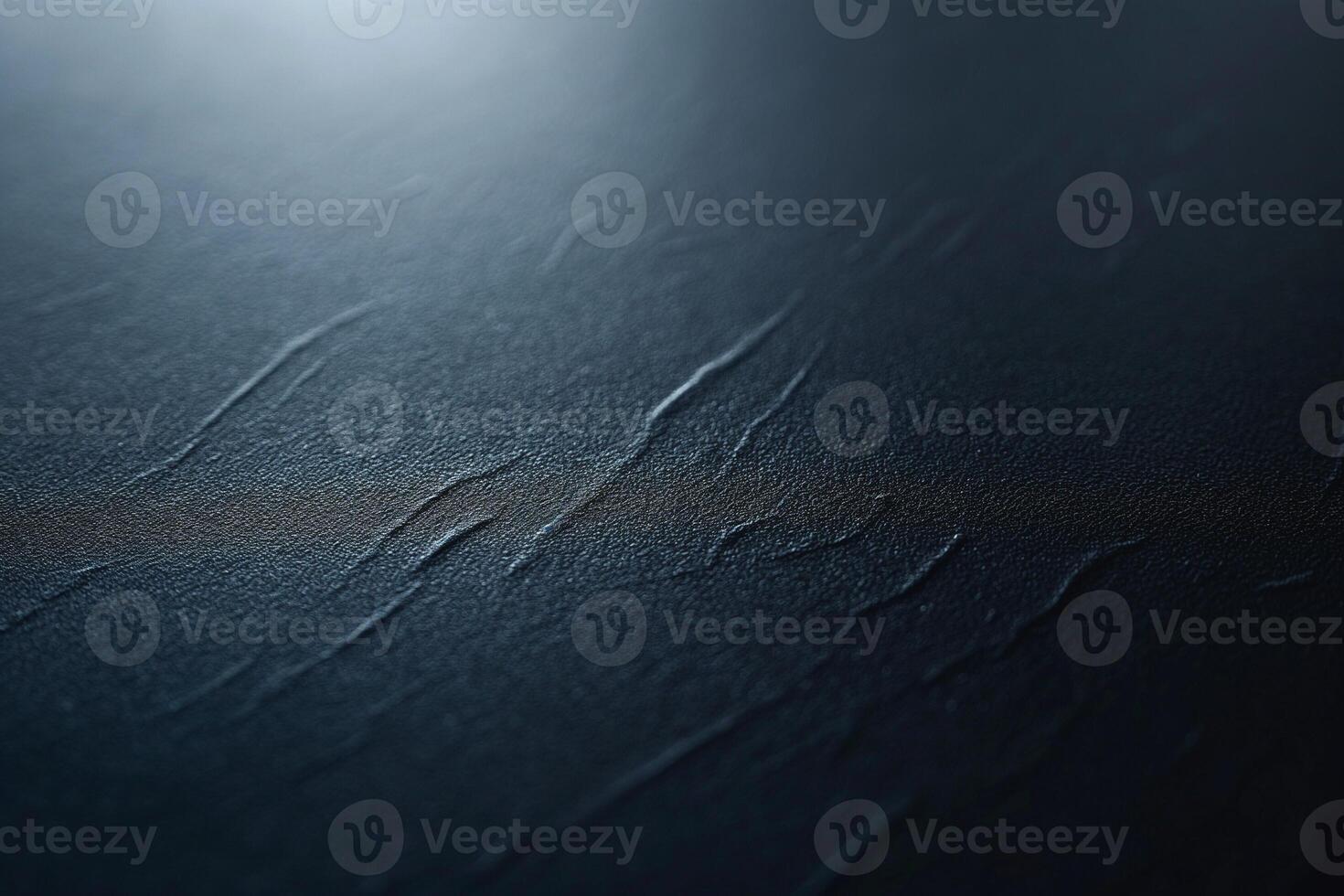 Close-up of textured dark surface with subtle grooves and a soft light reflection. photo