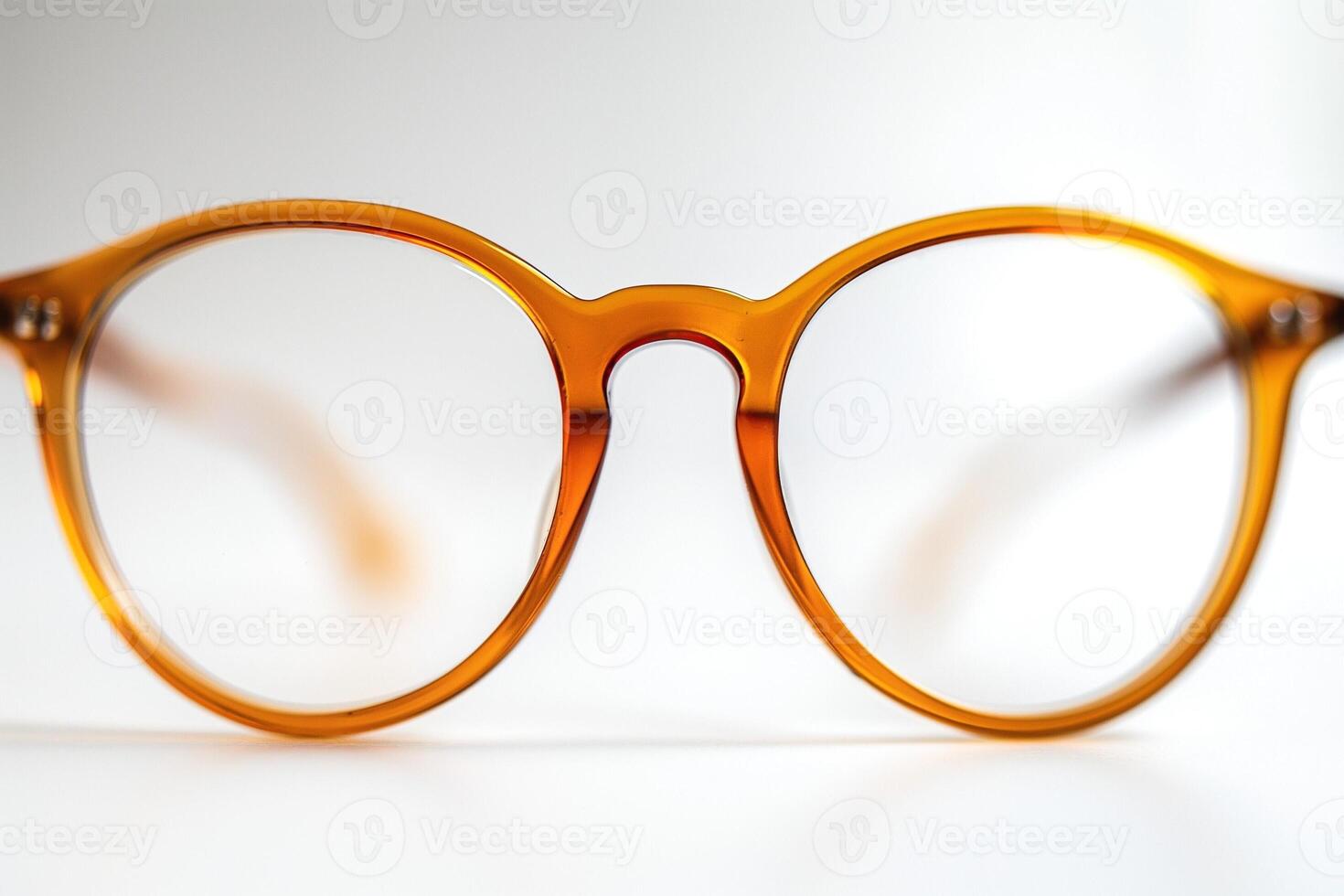 Stylish round amber glasses with a clear lens, enhancing modern fashion aesthetics. photo