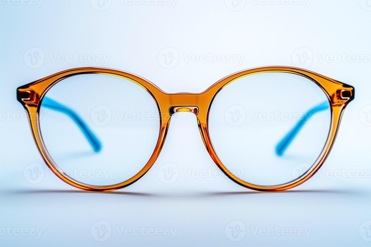 Stylish round eyeglasses with a vibrant orange frame and blue accents, set against a clean, minimal background. photo