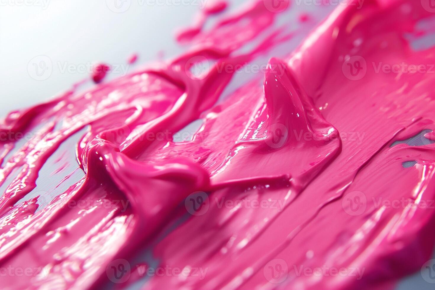 Close-up of vibrant pink paint swirls, showcasing texture and gloss. photo