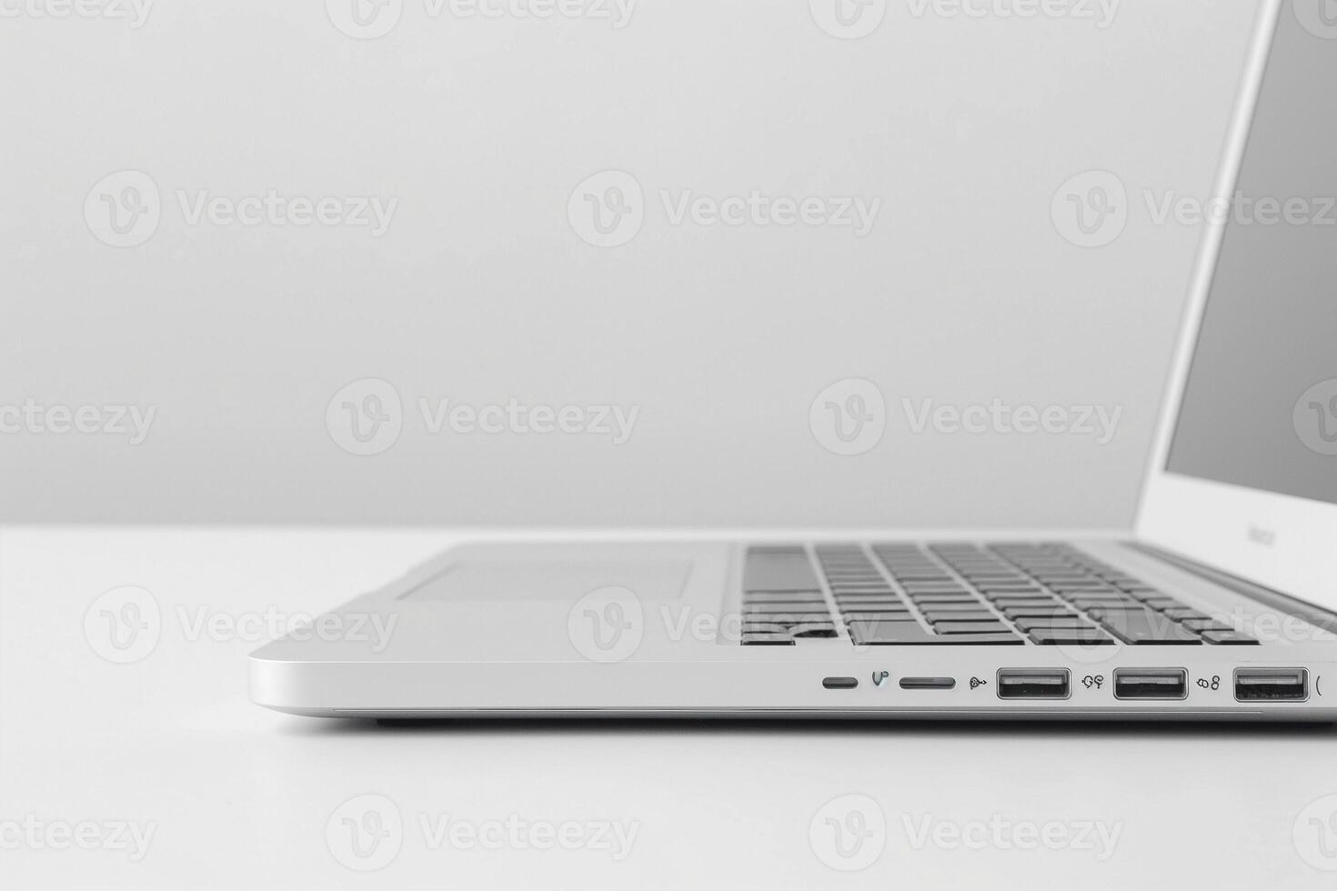 A sleek silver laptop viewed from the side, showcasing its minimalist design and multiple ports. photo