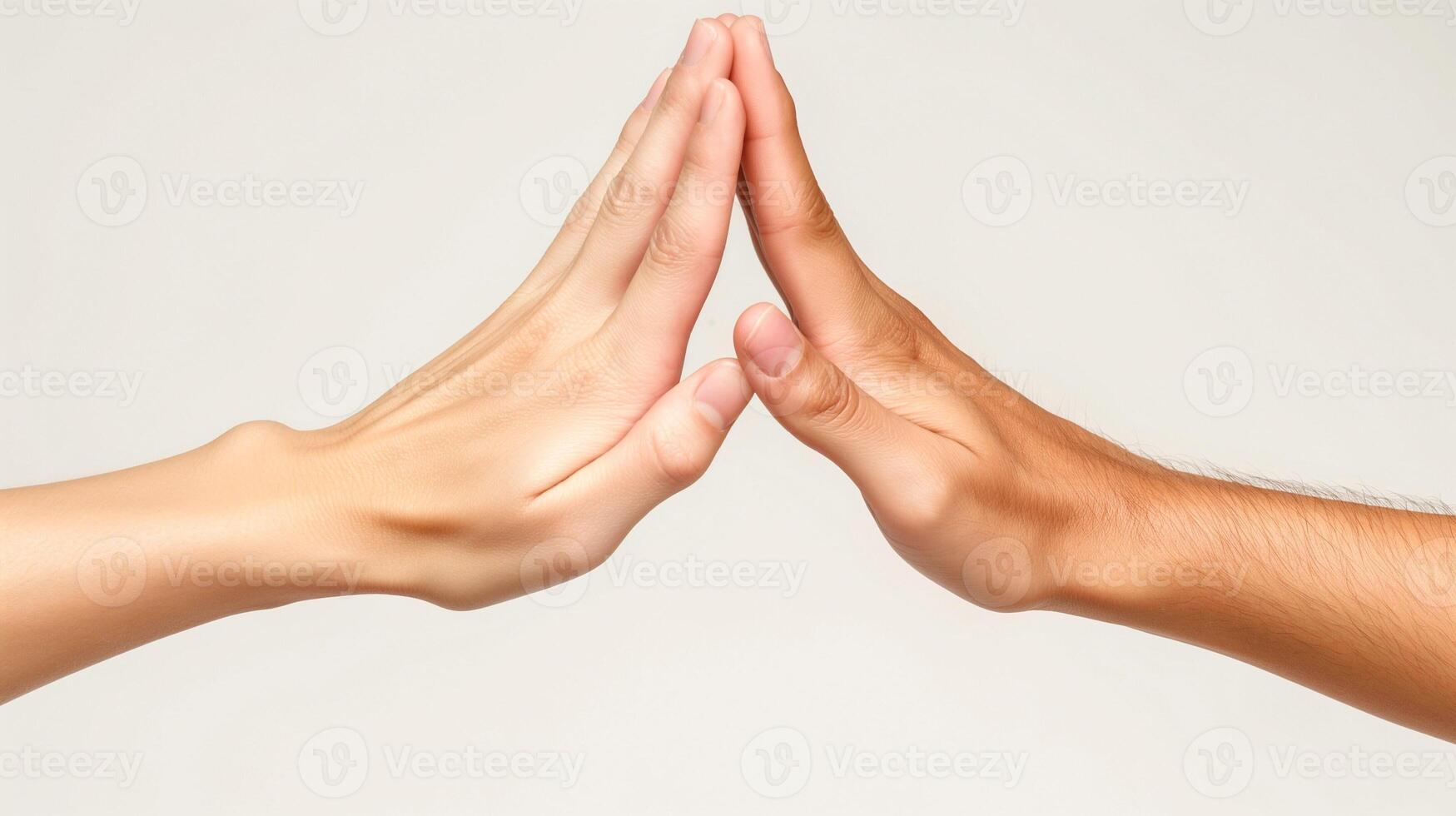 Two hands, one light and one dark, gently touch in a harmonious gesture of unity and connection. photo