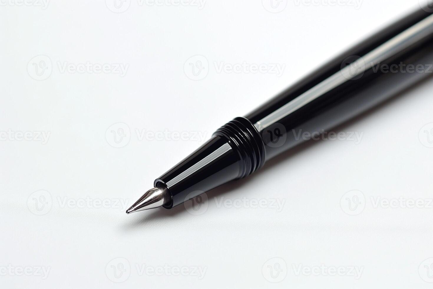 Close-up of a sleek black pen highlighting its precision tip against a clean white background. photo