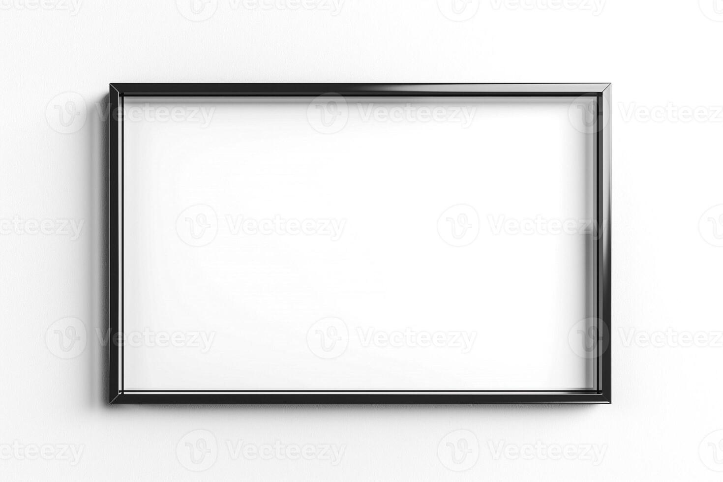 Empty black picture frame against a white wall, ready for artwork or photographs. photo