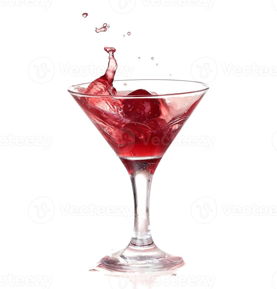 Splashing red wine in a glass. Isolated on white background photo