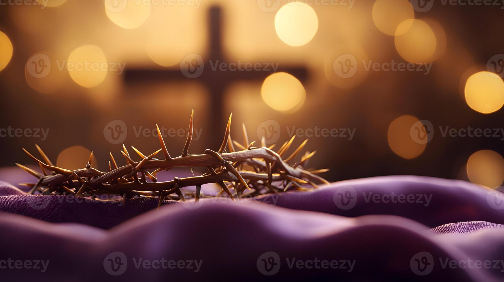Crown of Thorns with cross on purple clothe and warm bokeh background conveys sacrifice photo