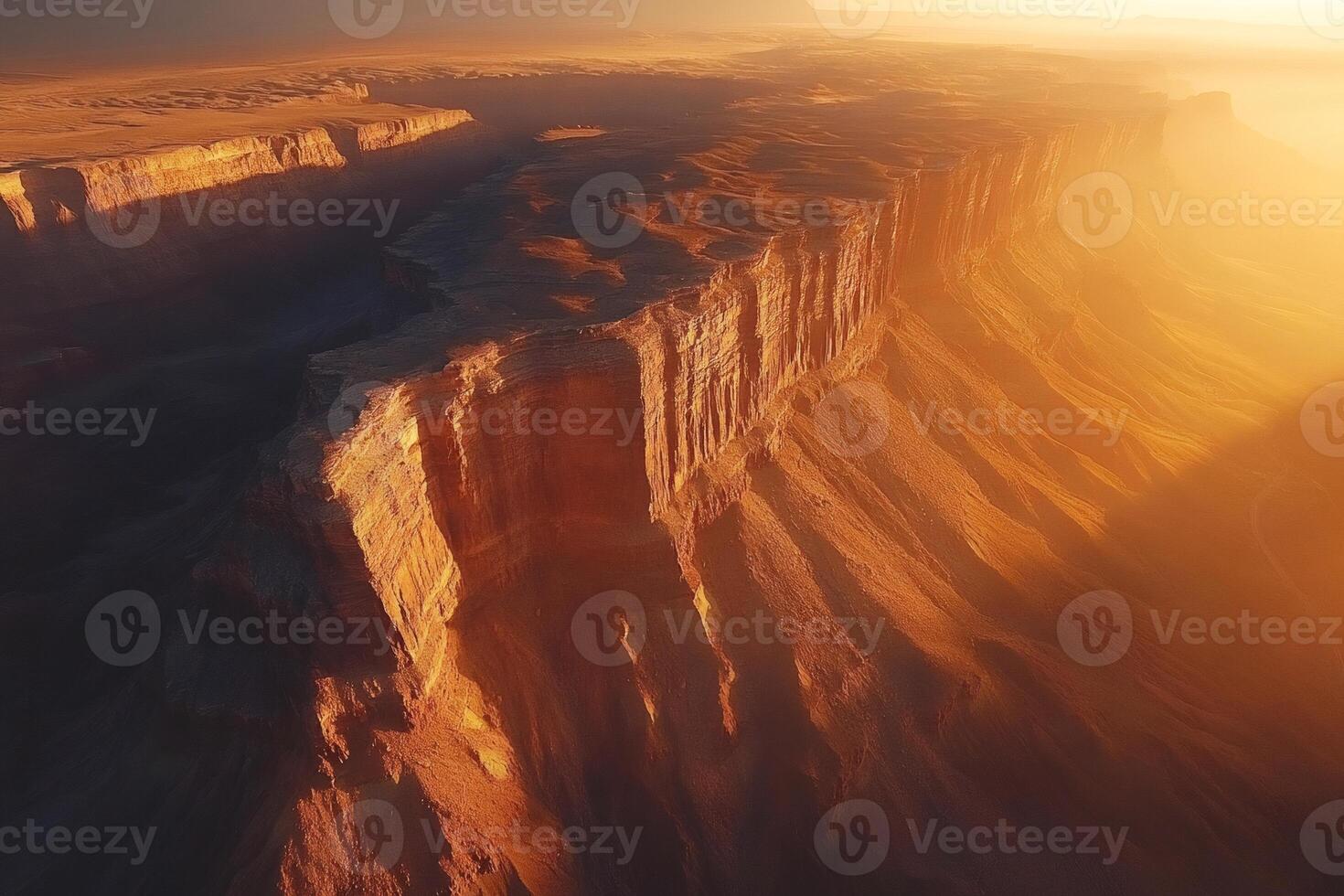 Sun shining on the edge of a canyon in a desert landscape photo