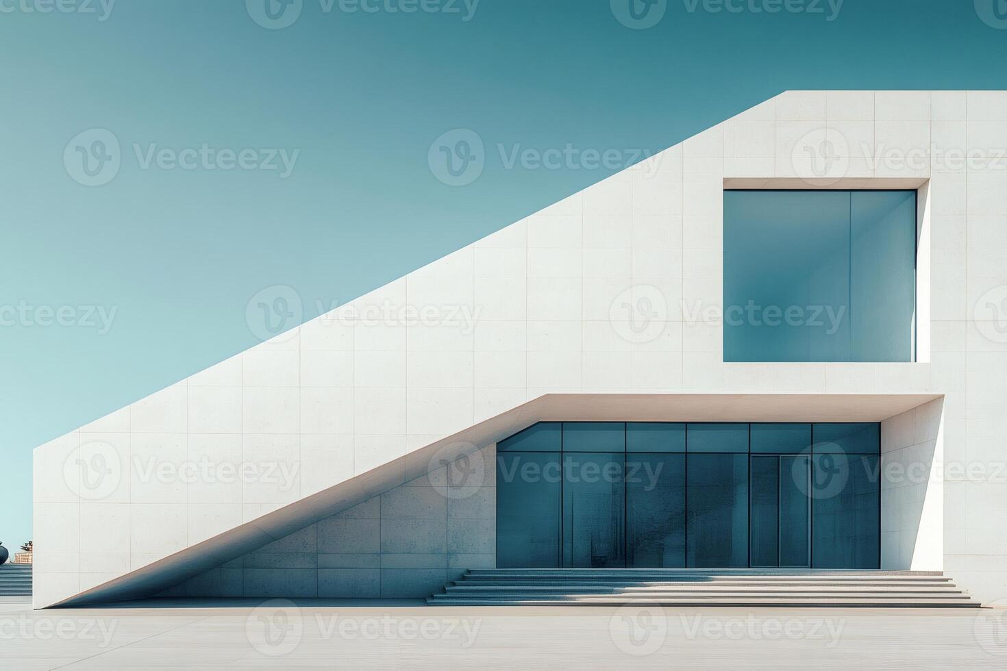 Modern white building with large windows reflecting blue sky photo