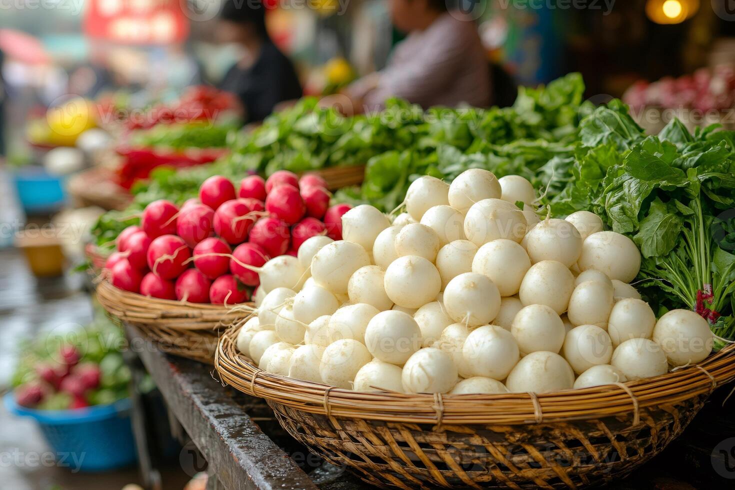 Farmer selling fresh white turnips and red radishes at the market photo