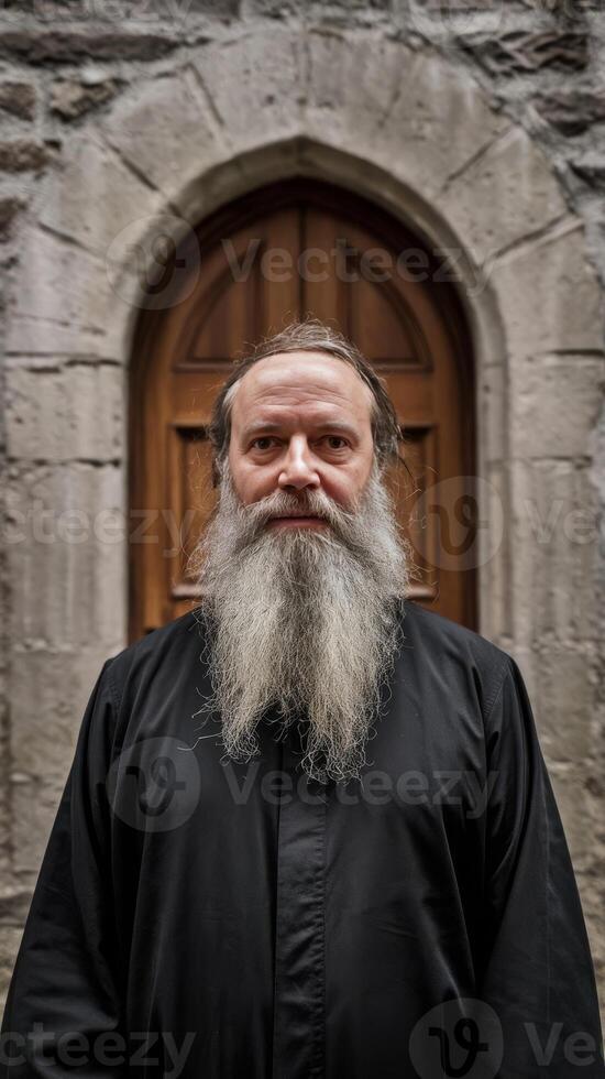 A bearded man with a long beard standing in front of a door photo